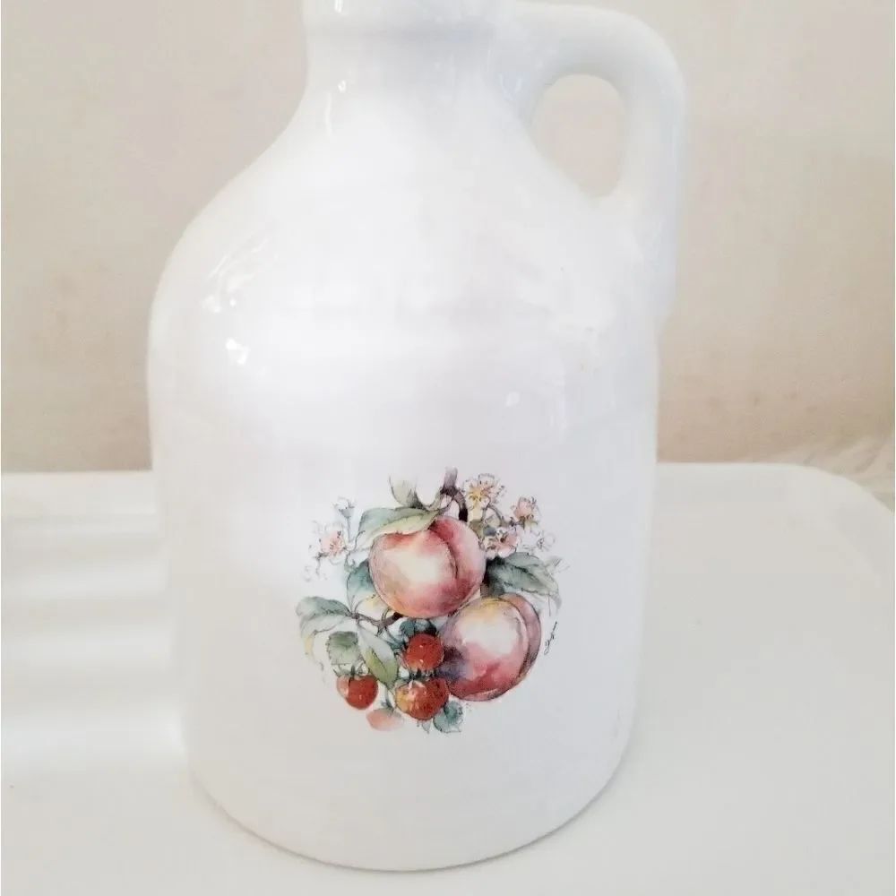 Fruit jug with peaches and strawberries